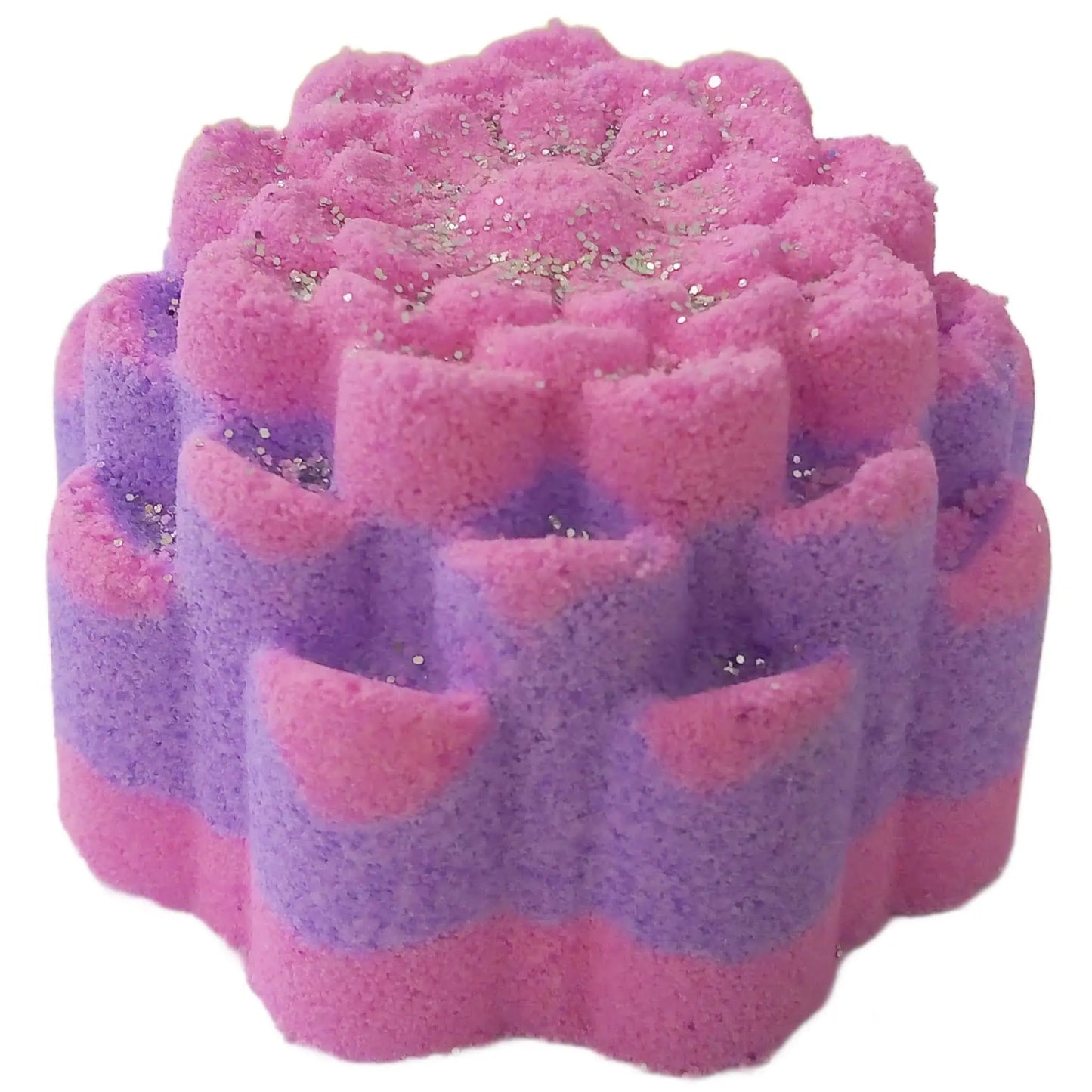 The Blackberry & Rhubarb Fizzy Bath Bomb by Posh Brats features a floral design in pink and purple hues, infused with natural ingredients. It exudes a sweet blackberry and rhubarb scent and is adorned with glitter for a sparkling effect.