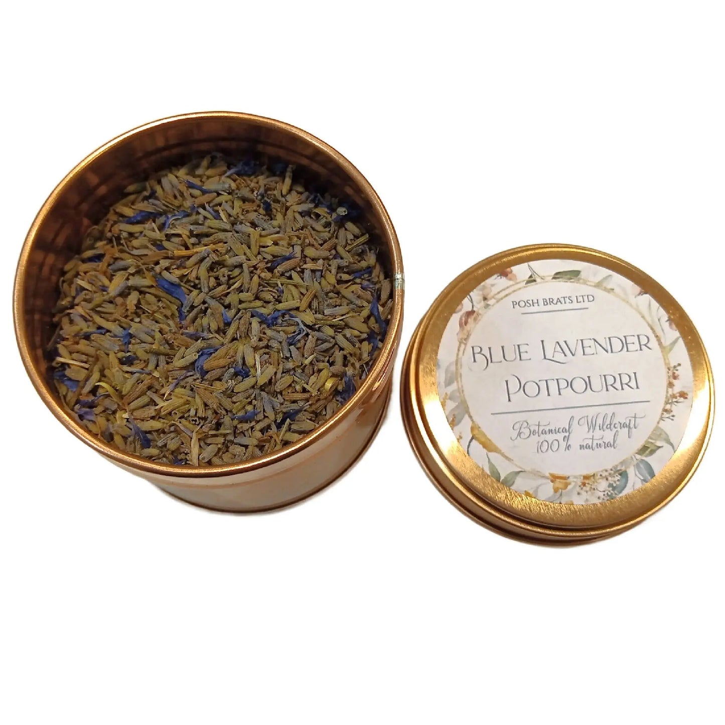 Open tin of dried blue lavender potpourri with the lid beside it. The label on the lid says Wildcraft Botanical Potpourri by Posh Brats, 100% Natural, and features a decorative floral design infused with botanical herbs.