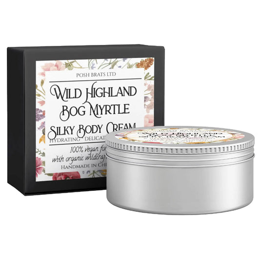 A silver tin of Posh Brats Wild Highland Bog Myrtle Silky Body Butter Cream sits beside its floral box, celebrated as a hydrating, vegan treat infused with highland herbs.