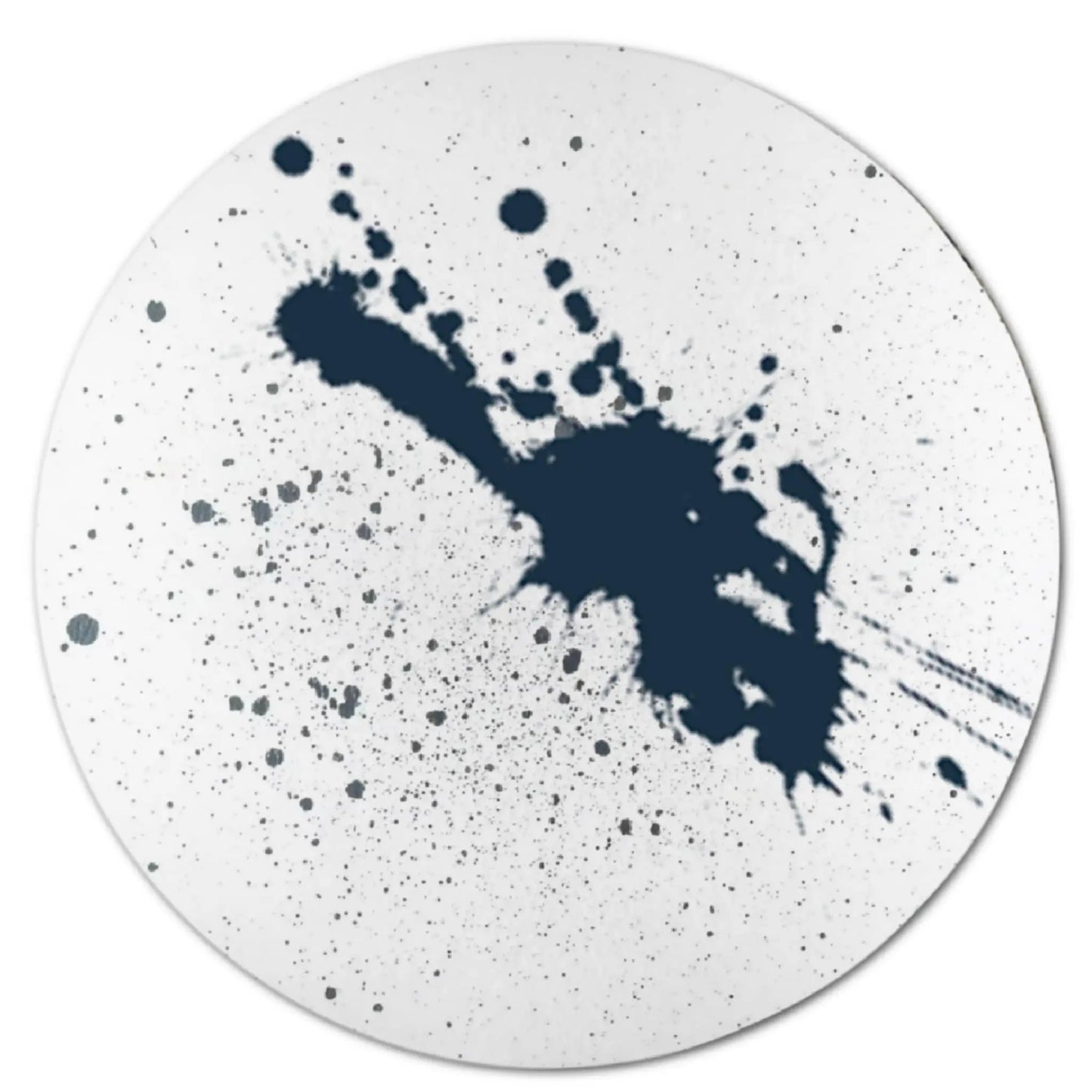 A white circular plate showcases an abstract design with a central black ink splatter reminiscent of the dispersal effect seen when using Posh Brats Cold Sinus Aromatherapy Bath Bomb to relieve sinus congestion.