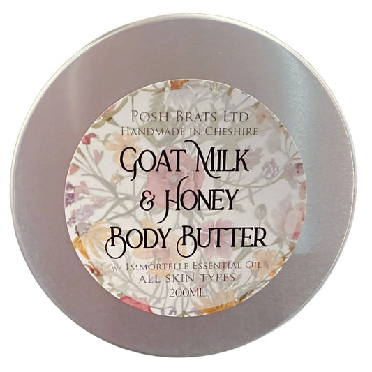 The Posh Brats Goat Milk & Honey Body Butter comes in a round silver tin and, set against a floral backdrop, offers a luxurious skincare experience. Infused with Immortelle oil and suitable for all skin types, this 200 ml container provides deep moisturizing benefits.
