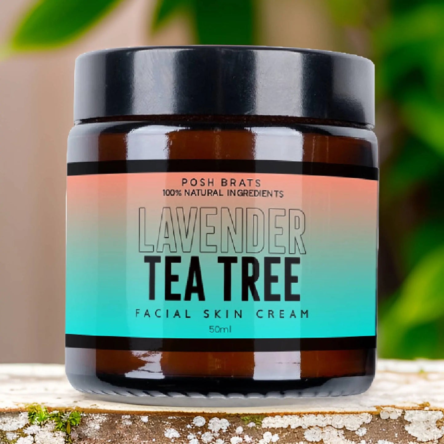 A jar of Posh Brats Lavender Tea Tree Clear Skin Cream, made with 100% natural ingredients, rests on rustic wood. Its label transitions from turquoise to peach. Softly blurred greenery in the background enhances its calming presence.