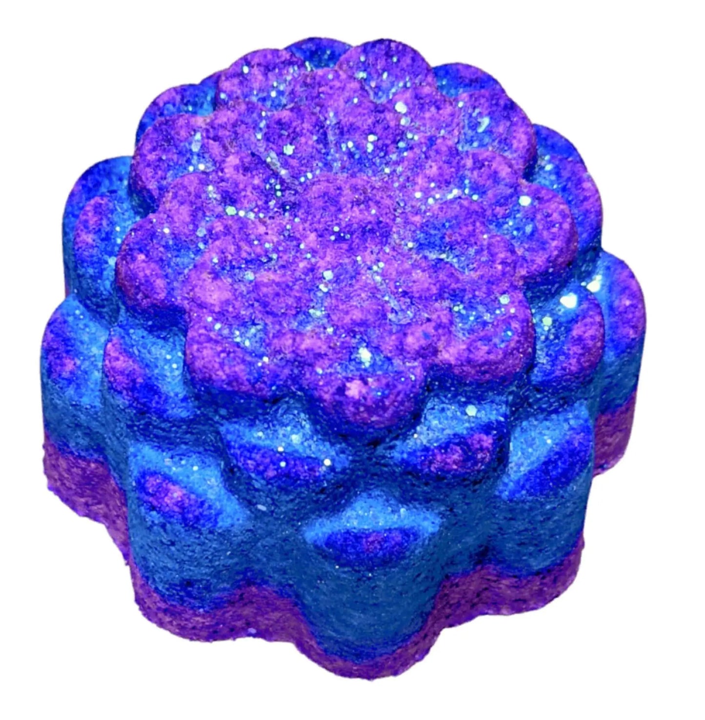 The sparkling blue and purple Desert Spa Fizzy Bath Bomb by Posh Brats, flower-shaped with a textured, glittery surface, offers a rejuvenating soak, transforming your bath into an oasis of relaxation and indulgence.