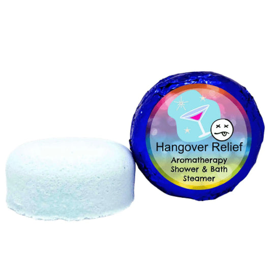 A white, round Hangover Relief aromatherapy shower steamer from Posh Brats sits beside its colorful, blue packaging with a cocktail icon. Infused with essential oils, it promises an uplifting experience and ensures a delightful start to your day.