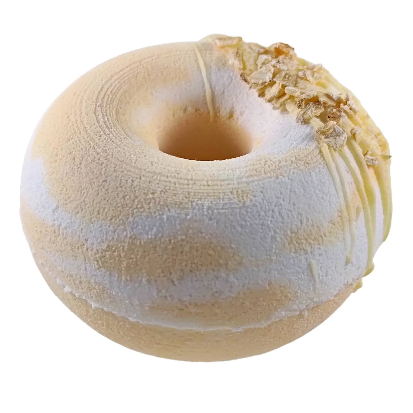 Introducing Posh Brats Honey Oatmeal Donut Fizzy Bath Bomb: a vegan, donut-shaped bath bomb with a creamy beige color, subtle white swirls, and oatmeal flakes, offering an ultimate moisturizing experience.