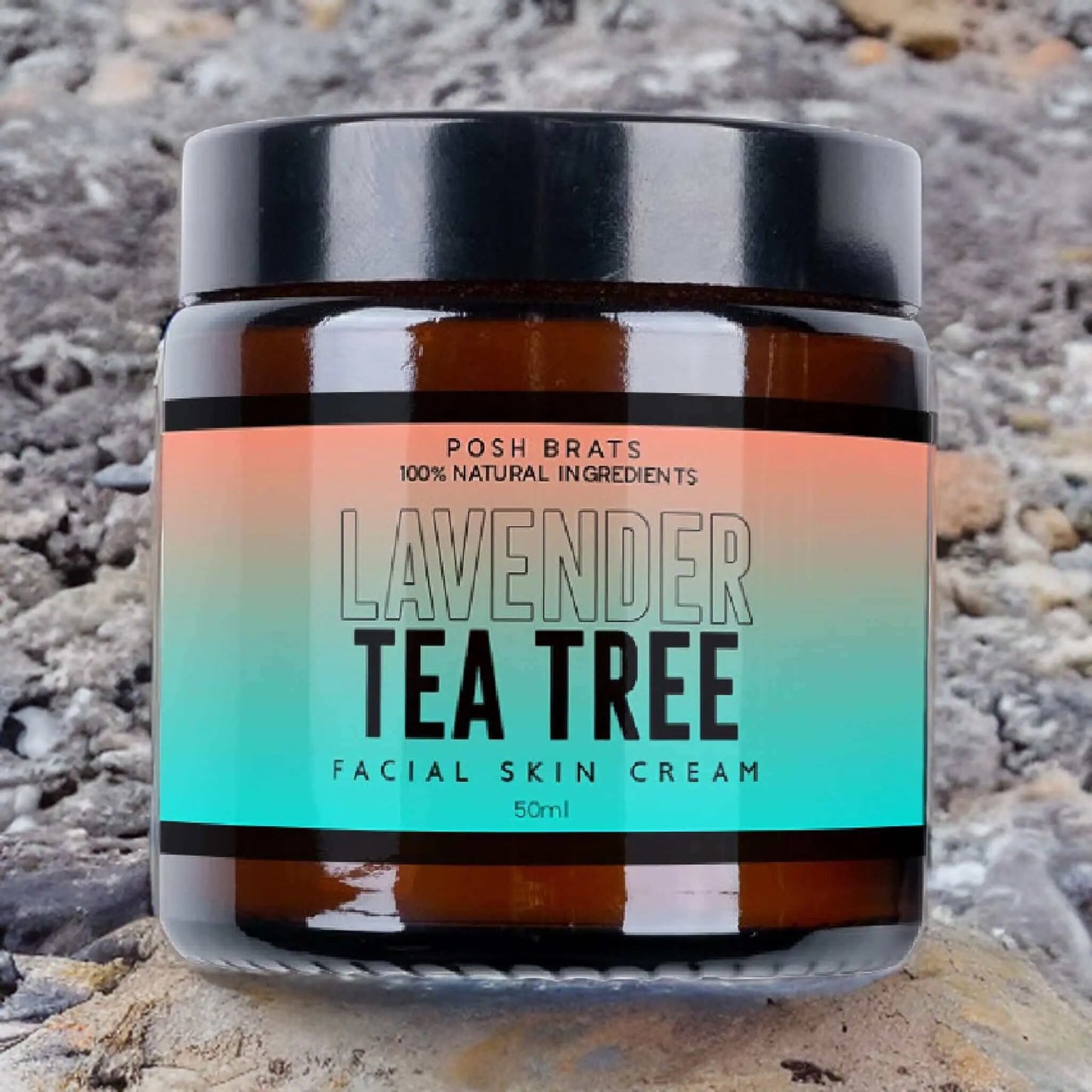 Posh Brats Lavender Tea Tree Clear Skin Cream, featuring natural tea tree oil and lavender ingredients, sits on a rocky surface with its gradient label.