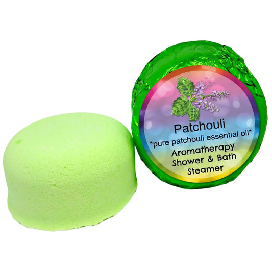 The Posh Brats Patchouli Aromatherapy Shower Steamer is a green shower steamer wrapped in green foil and features a colorful label with patchouli leaves and flowers, infused with patchouli essential oils.