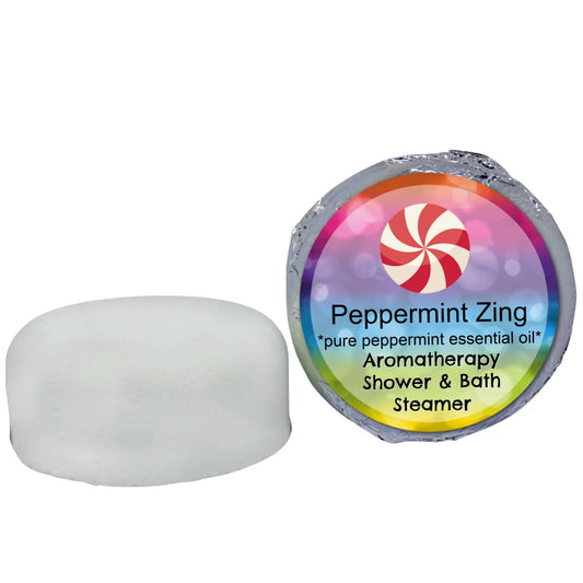 Two shower steamers: an unwrapped white disk and one in colorful foil. Text: Peppermint Zing Aromatherapy Shower Steamer by Posh Brats, features pure peppermint essential oil, capturing the invigorating essence of natural oils.