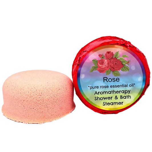 A pink round bath steamer, beside its wrapped counterpart with a bright label, highlights the Rose Aromatherapy Shower Steamer by Posh Brats. It features red roses and reads: Pure rose essential oil, Aromatherapy Shower & Bath steamer for a luxurious spa experience.