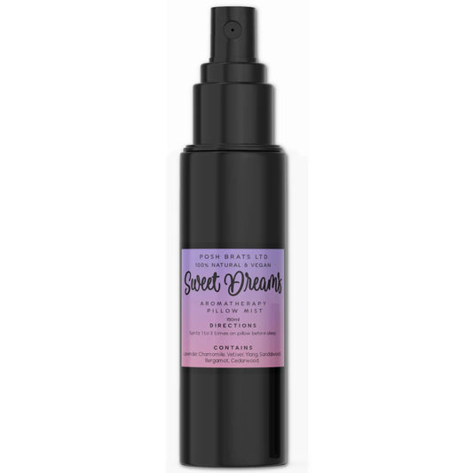 The Sweet Dreams Magnesium Aromatherapy Pillow Mist by Posh Brats comes in a black spray bottle with a purple label, featuring 100% natural and vegan ingredients like lavender, chamomile, ylang-ylang, bergamot, and cedarwood for serene, restful nights.
