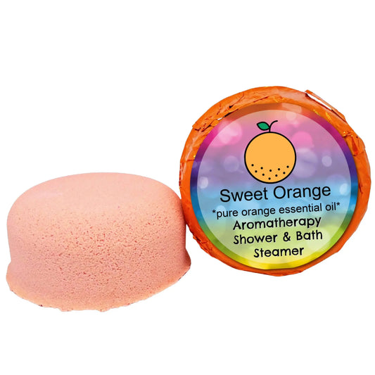 The Posh Brats Sweet Orange Aromatherapy Shower Steamer, dome-shaped and infused with essential oils, provides a burst of aromatherapy. Its vibrant packaging features an orange fruit graphic, promising an exceptional shower and bath experience.