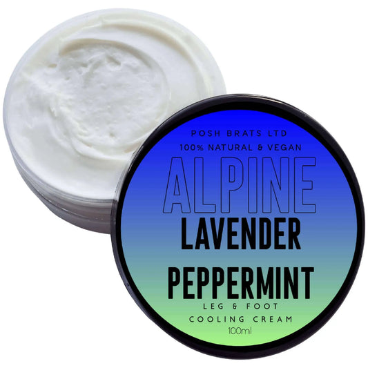 A jar of Alpine Lavender Peppermint Leg + Foot Cream from Posh Brats is ideal for moisturizing feet. Featuring a lid with Alpine Lavender Peppermint, its round container has a gradient blue-green label, while the smooth white cream inside offers ultimate hydration.