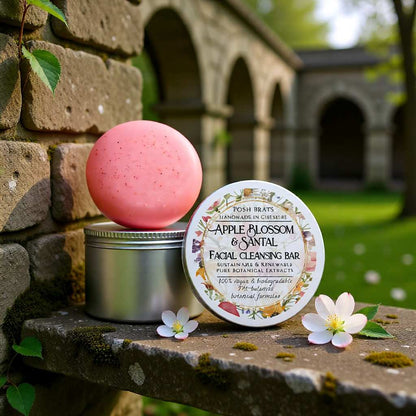 Facial cleansing bar with packaging on a stone ledge outdoors