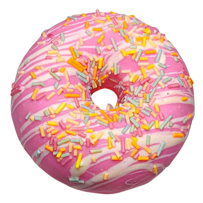 Treat yourself to a luxurious bath with Posh Brats Berry Vanilla Sprinkle Donut Bath Bomb, a vegan delight inspired by a pink frosted donut with white icing and colorful jimmies.
