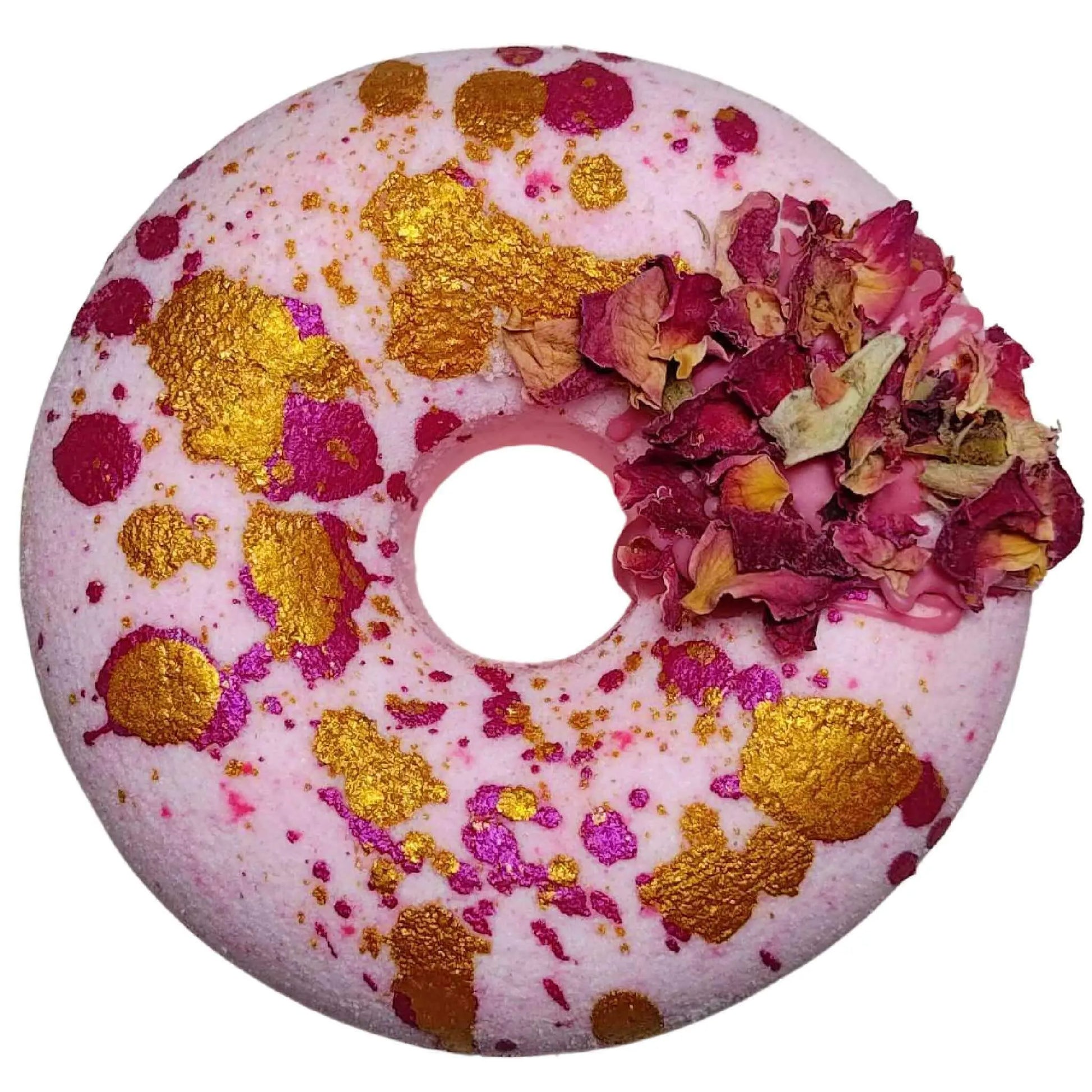 Introducing the Moonlight Kiss Donut Bath Bomb by Posh Brats, featuring a white and pink marbled design with gold and pink speckles. A small cluster of dried rose petals adorns one side, offering an aromatic journey of elegance.