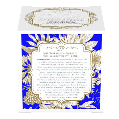 The Relax Aromatherapy Bath Bomb by Posh Brats comes in a white box with gold floral designs on a blue background. It features colloidal gold, salts, and essential oils and is labeled Anti-Acne Detox with storage tips. Made in Cheshire, UK, it offers stress-relief benefits.